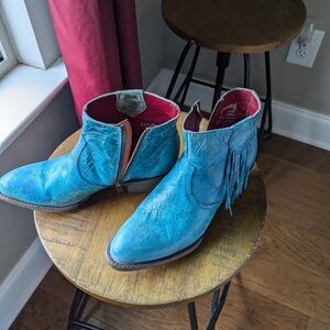 Turquoise ankle boot with fringe.